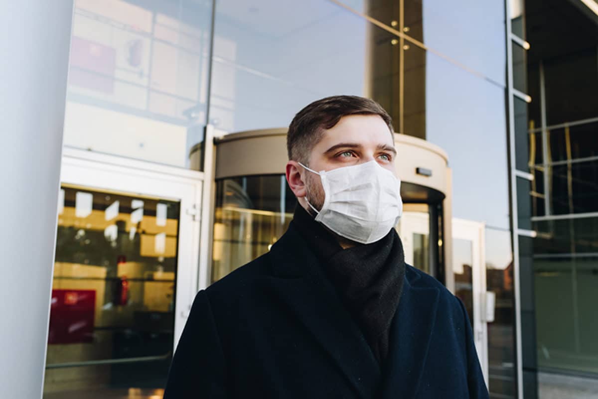 Young man wearing mask considers the future