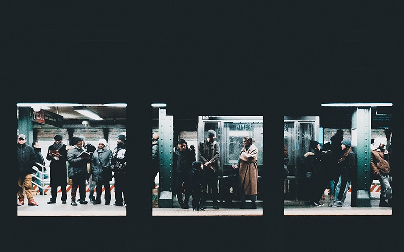 People wait on the subway platform
